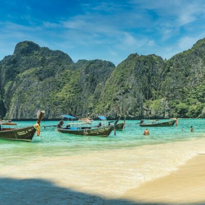 people riding on boat on beach during daytime